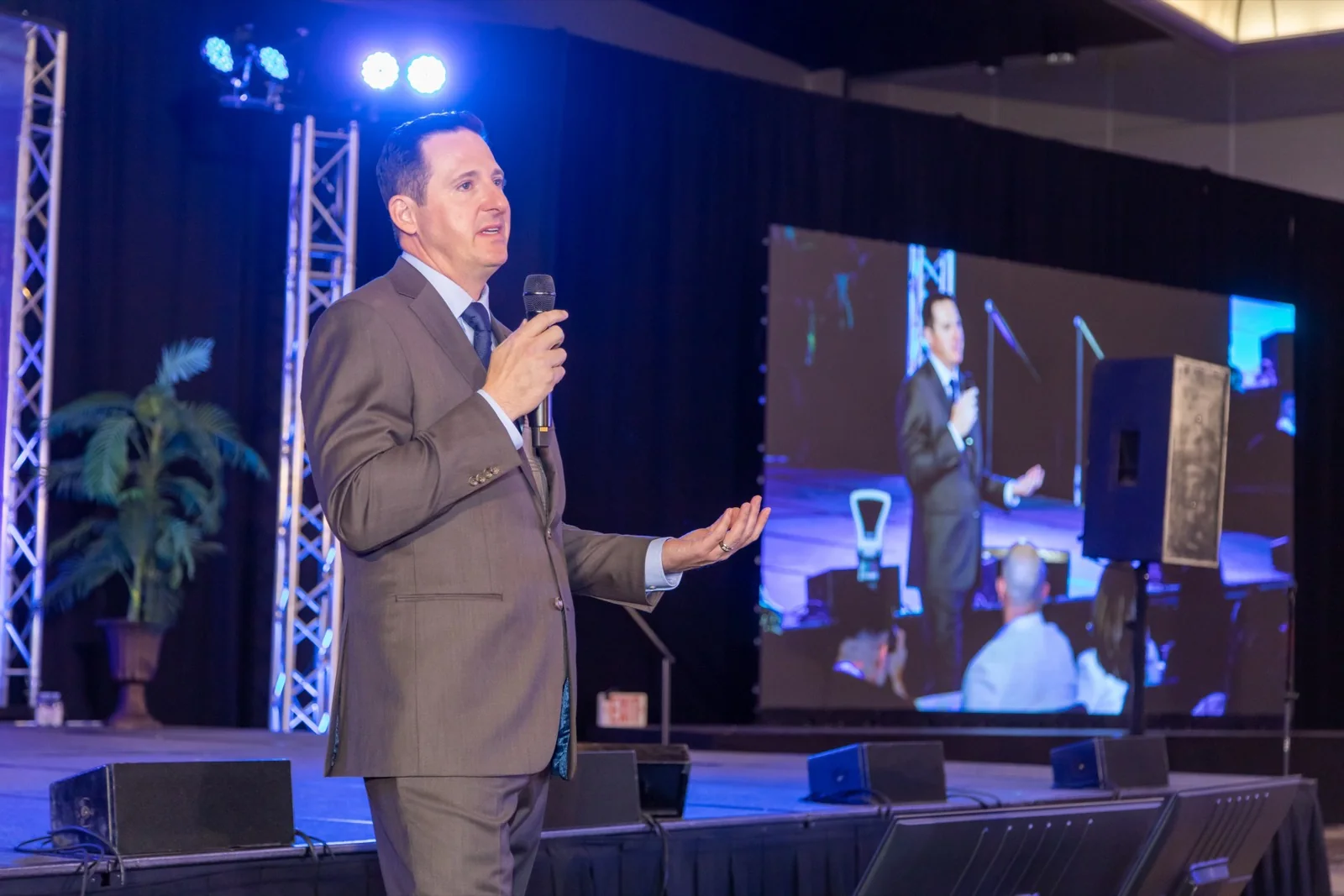 A conference speaker on stage, filmed close for a general session