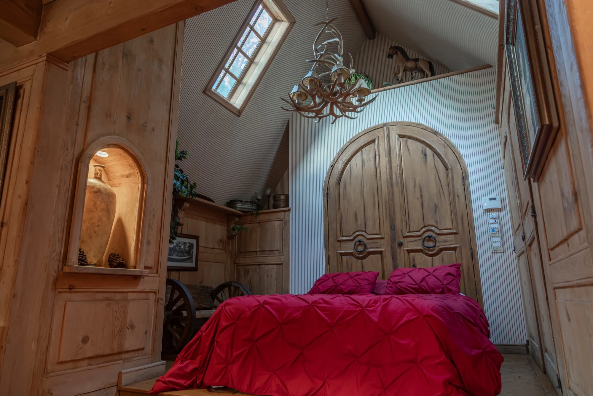 The arched plank doors of a bedroom at The Enchanted Manor