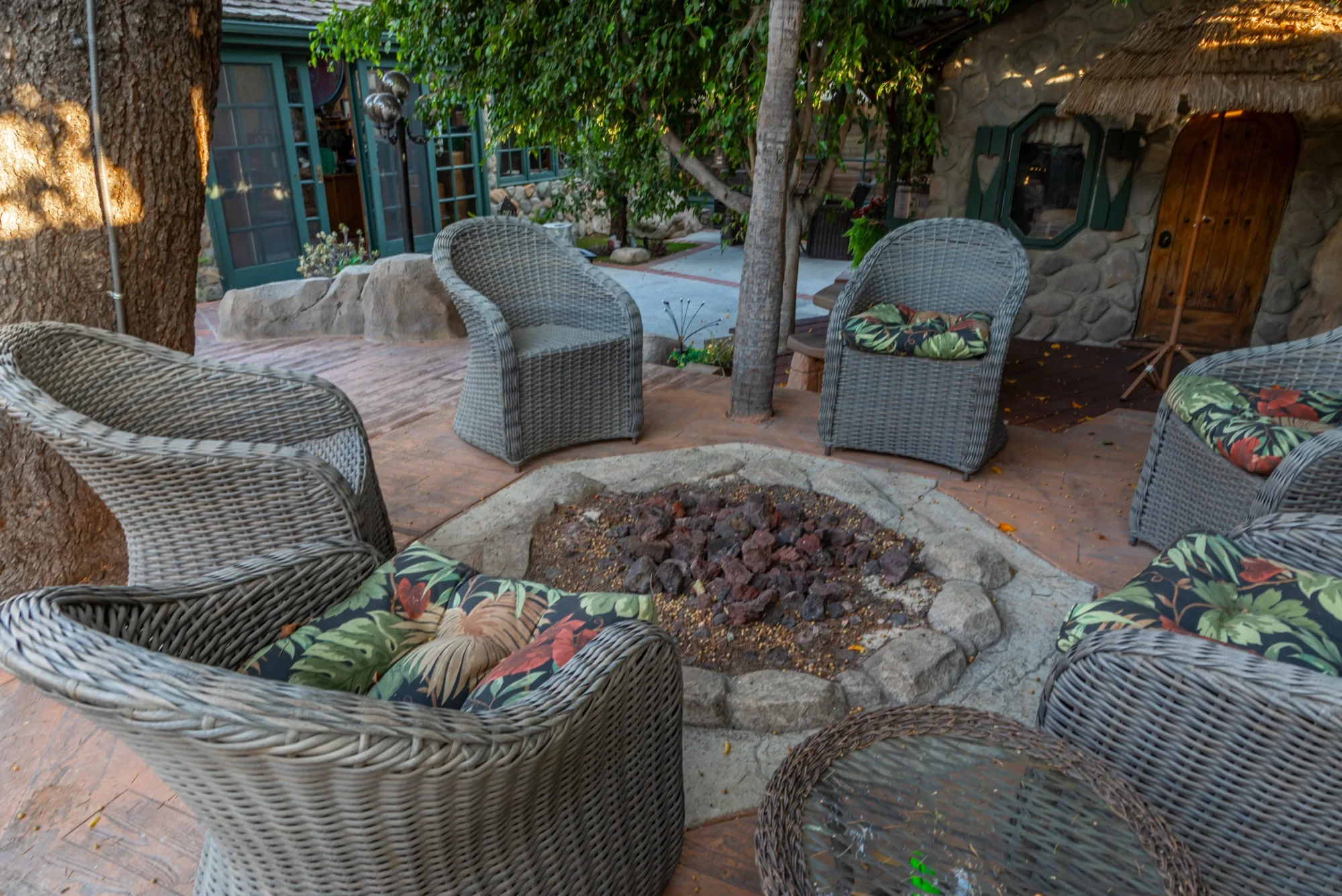 The sunken fire pit and wicker chairs at The Enchanted Manor