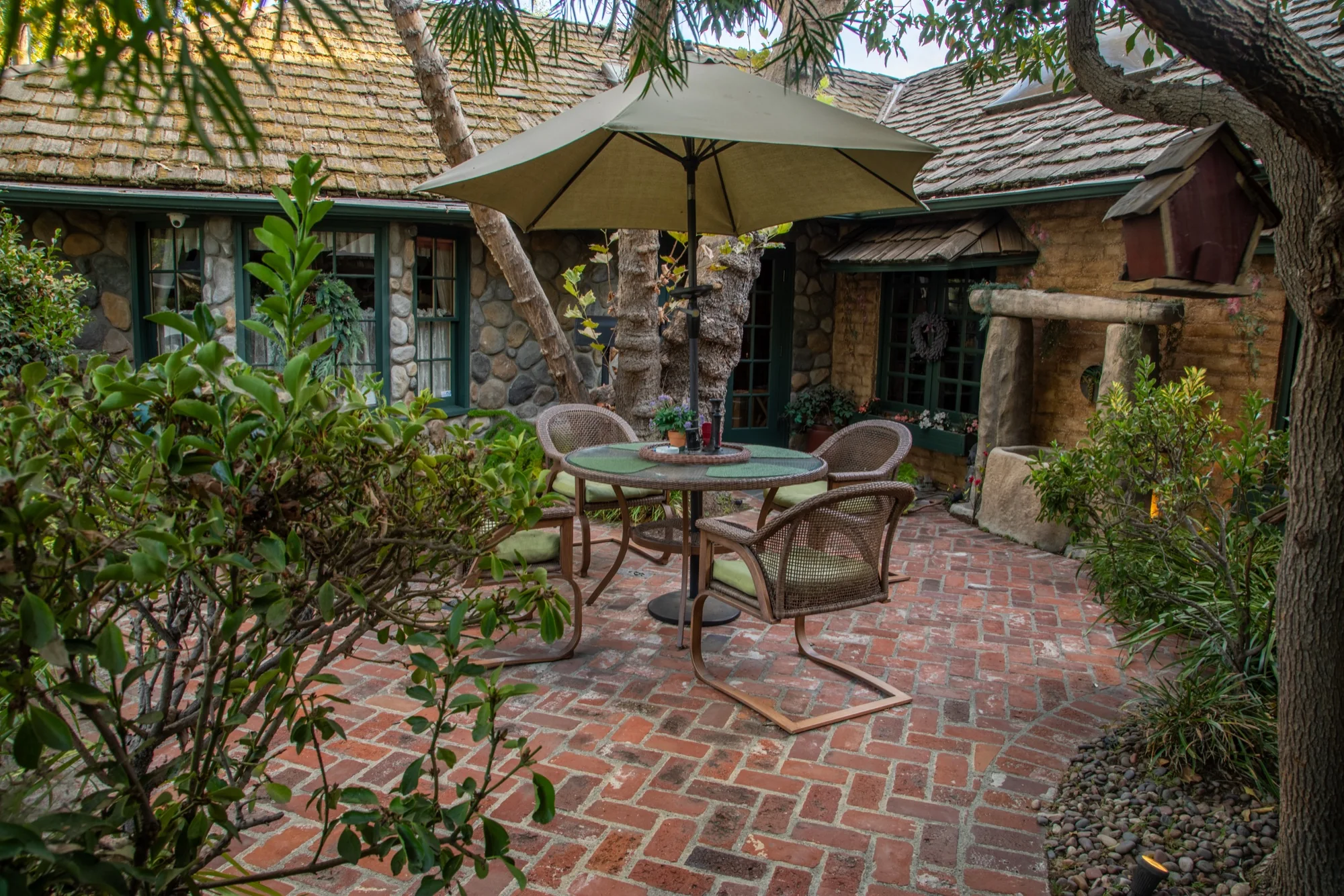 The brick patio beside the stone cottages at The Enchanted Manor