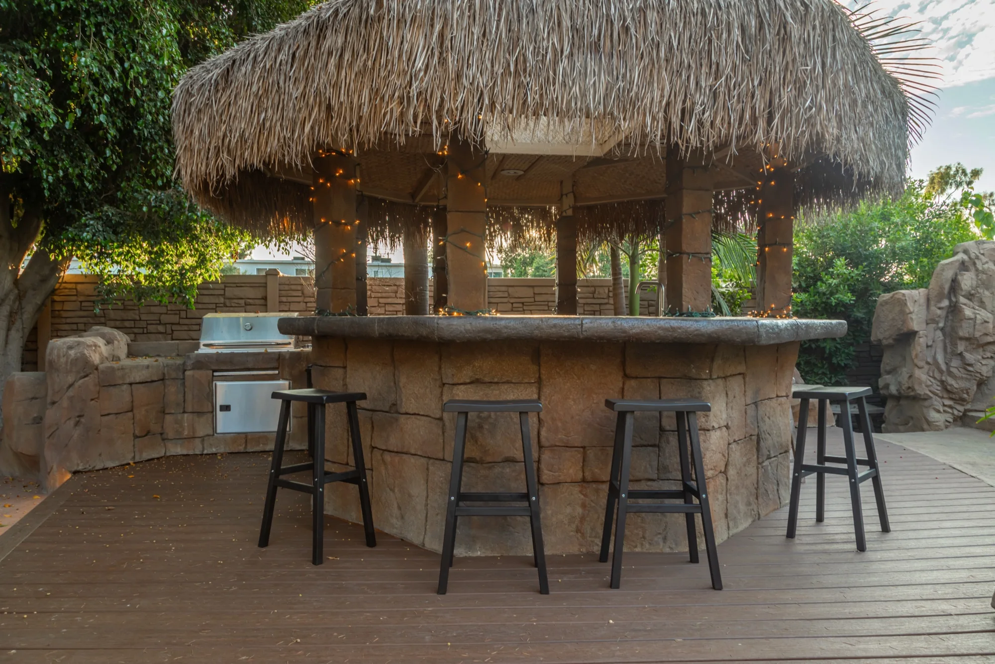 The thatched gazebo bar and its stools at The Enchanted Manor