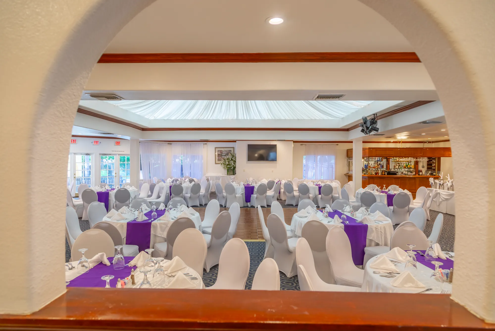 The banquet room seen through a plaster arch from the entry at Kelly's Wedding Garden