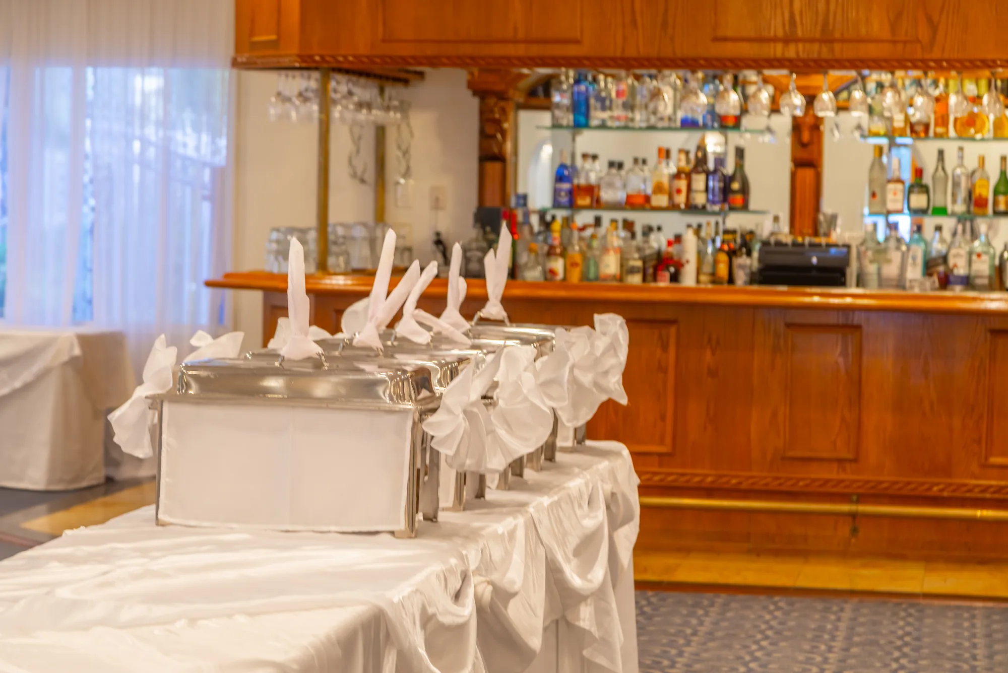Chafing dishes on the buffet line in front of the bar at Kelly's Wedding Garden