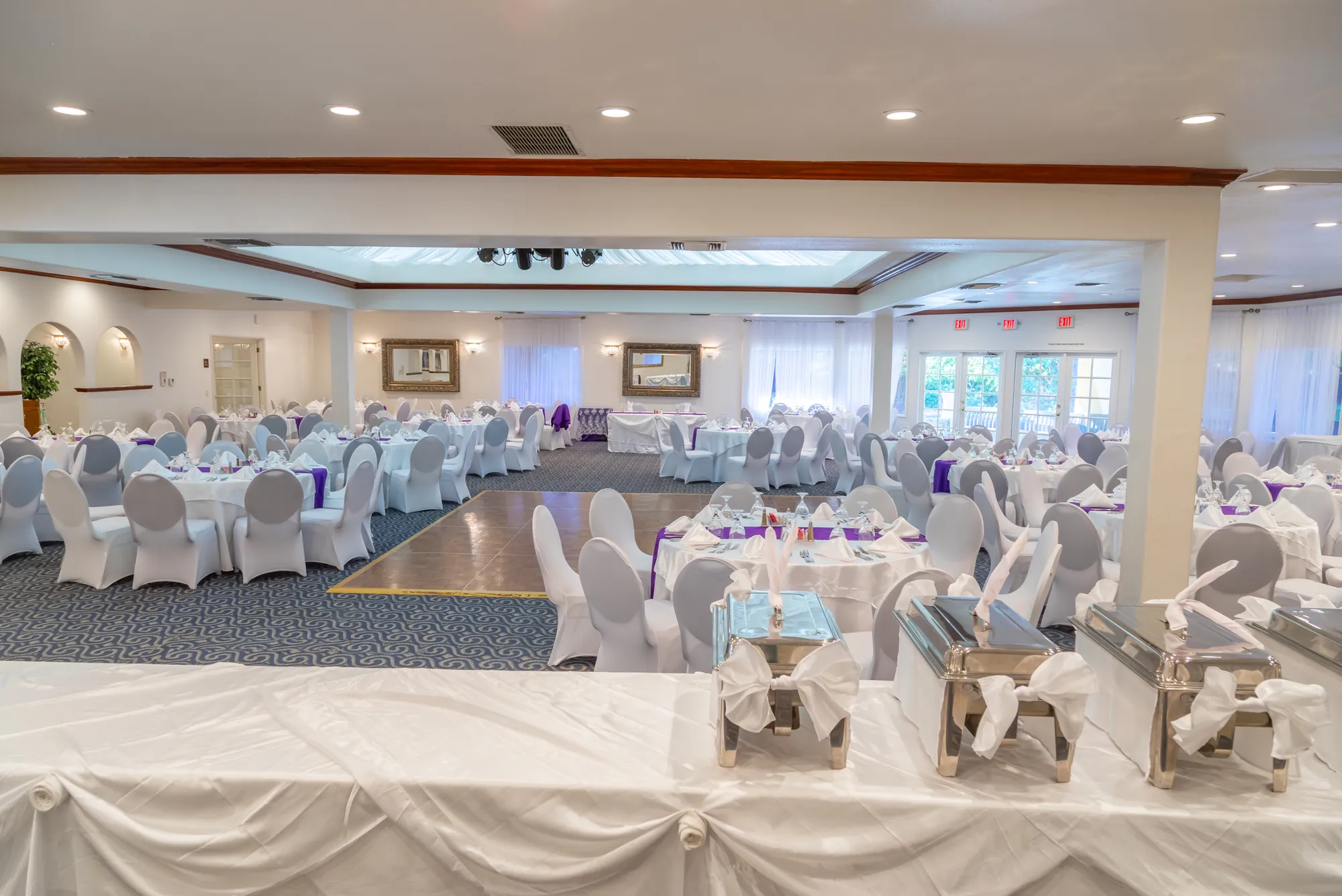 Chafing dishes on the buffet with the banquet room behind at Kelly's Wedding Garden