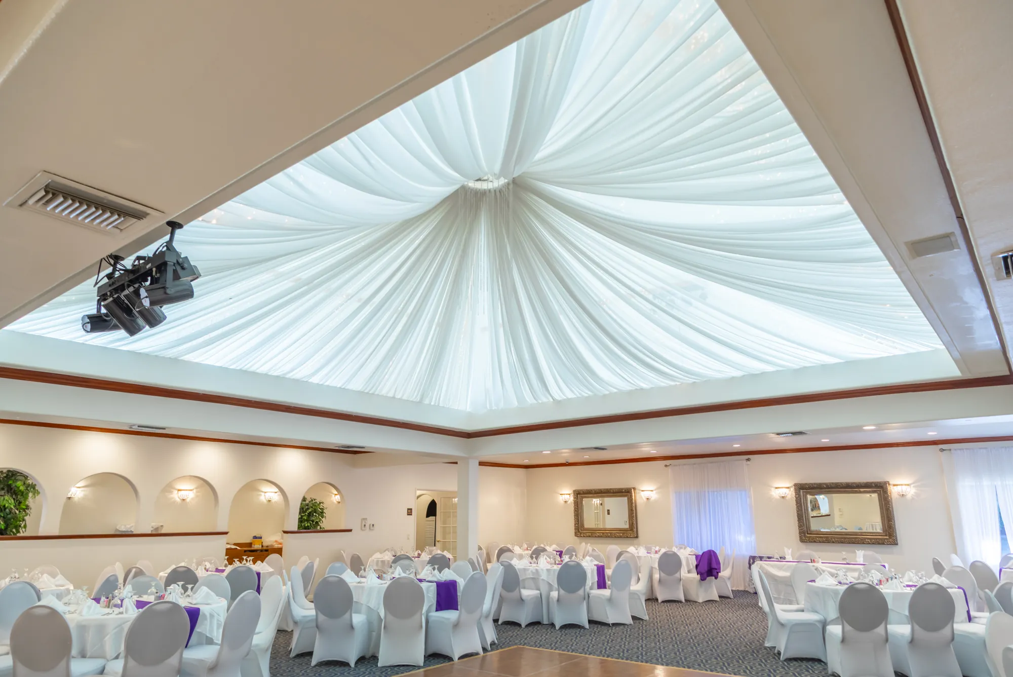 The draped, lit ceiling above the banquet room at Kelly's Wedding Garden