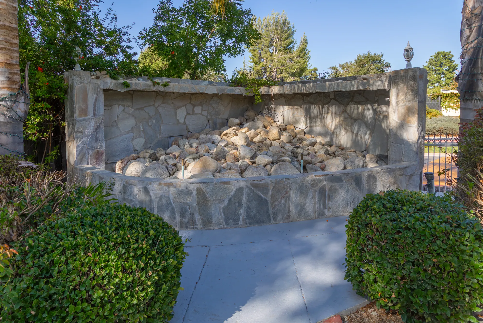 The stone waterfall wall at the edge of the garden at Kelly's Wedding Garden