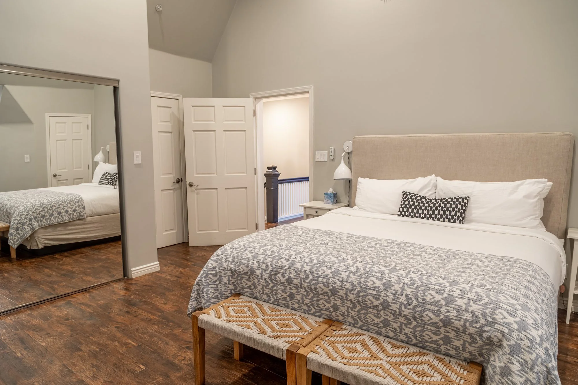 A second bedroom suite at Lombardi House with a full-length mirror