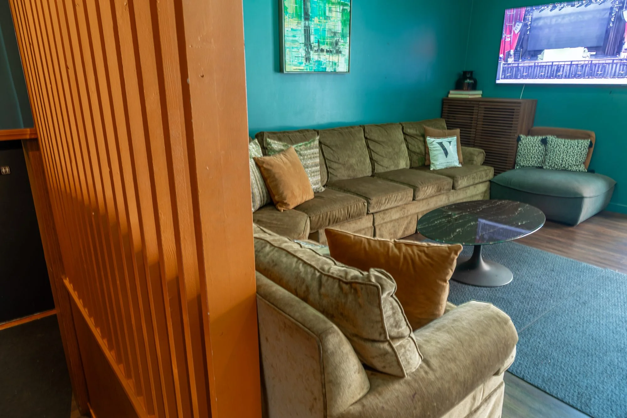 Sofas behind the timber screen in a green room at The Vermont Hollywood