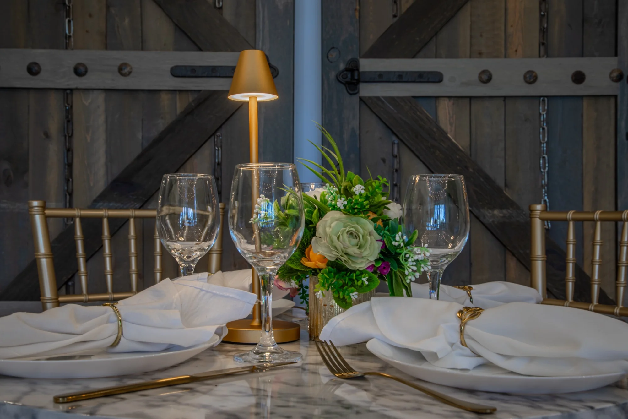 Flowers and glassware on a table by the doors at Violet Cactus Studio