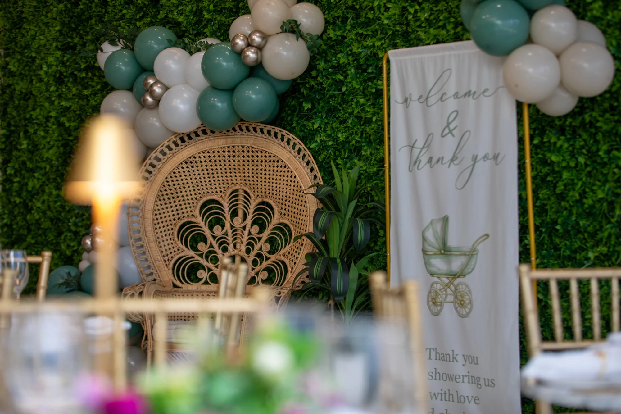 A balloon arch and welcome sign against the hedge wall at Violet Cactus Studio