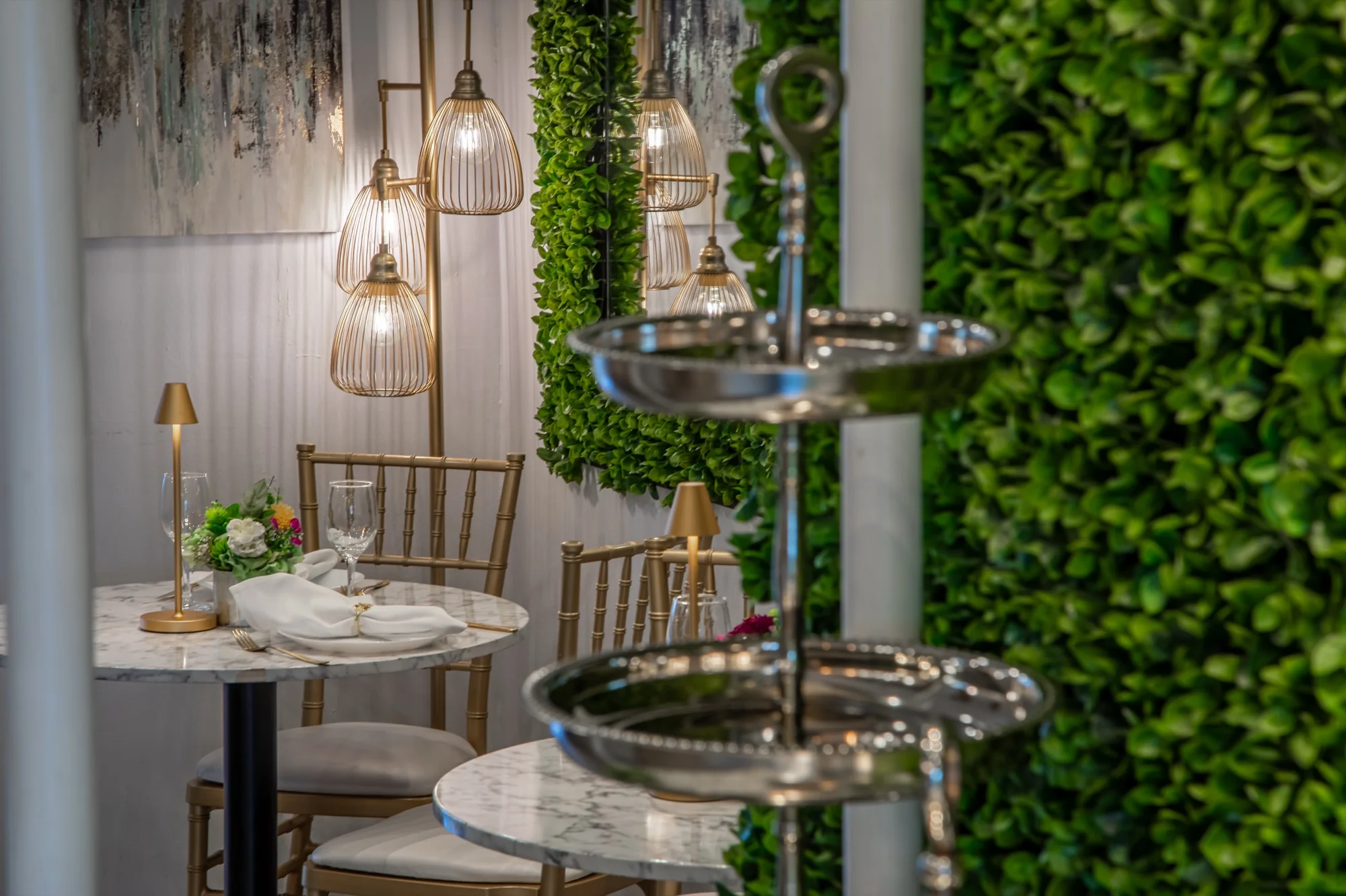 Cake stands set in front of the hedge wall at Violet Cactus Studio