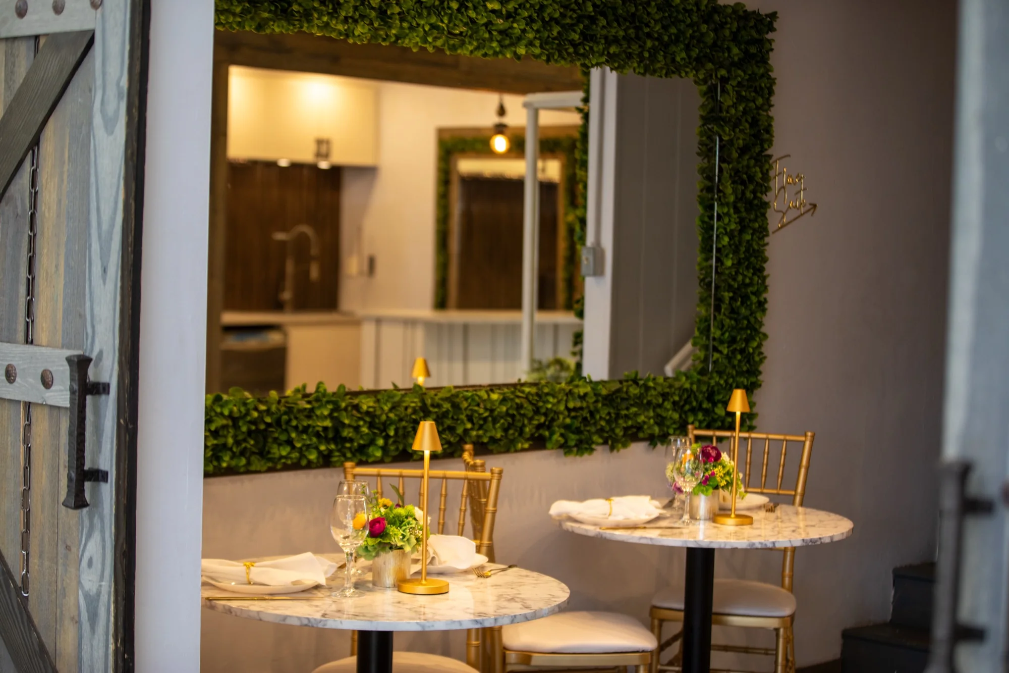 A table set in front of the mirrored hedge wall at Violet Cactus Studio