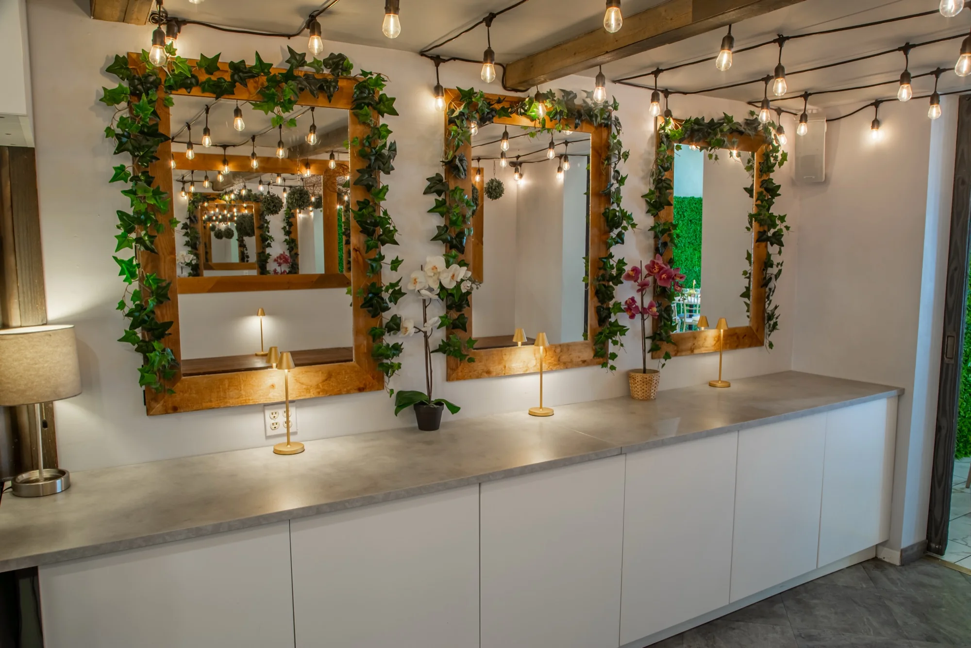 Vine-wrapped mirrors and string lights at Violet Cactus Studio