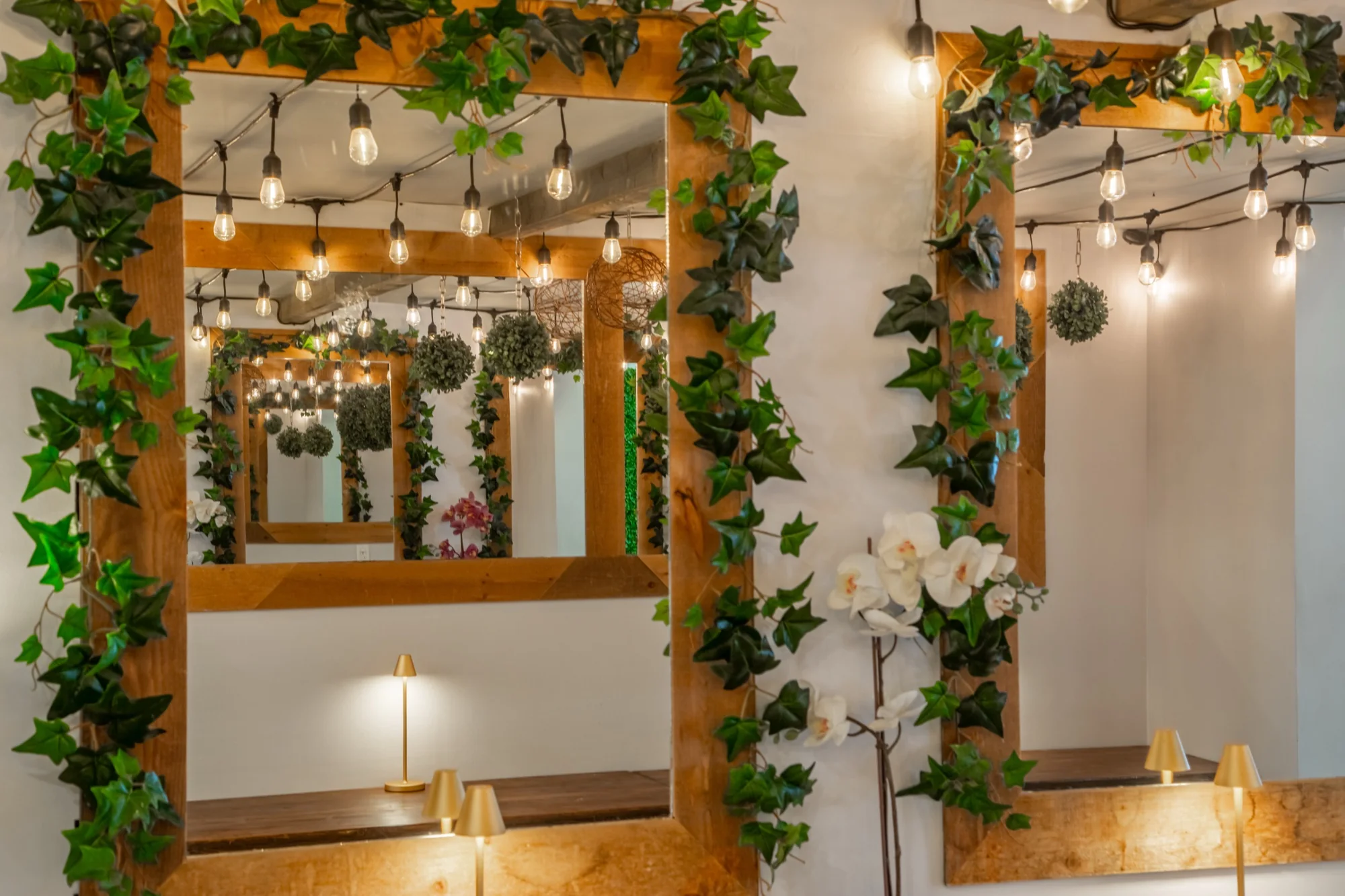 Mirrors, orchids and filament bulbs at Violet Cactus Studio